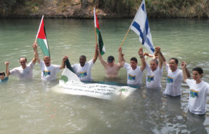 On Aug. 15, 2010, under the auspices of EcoPeace Middle East, Israeli, Palestinian and Jordanian mayors, municipal representatives and young activists “jumped” into the Jordan River. The action, which took place at the Yardenit baptism site near the Sea of Galilee, called on governments to rehabilitate the polluted waterway. (Photo: Courtesy of EcoPeace Middle East).